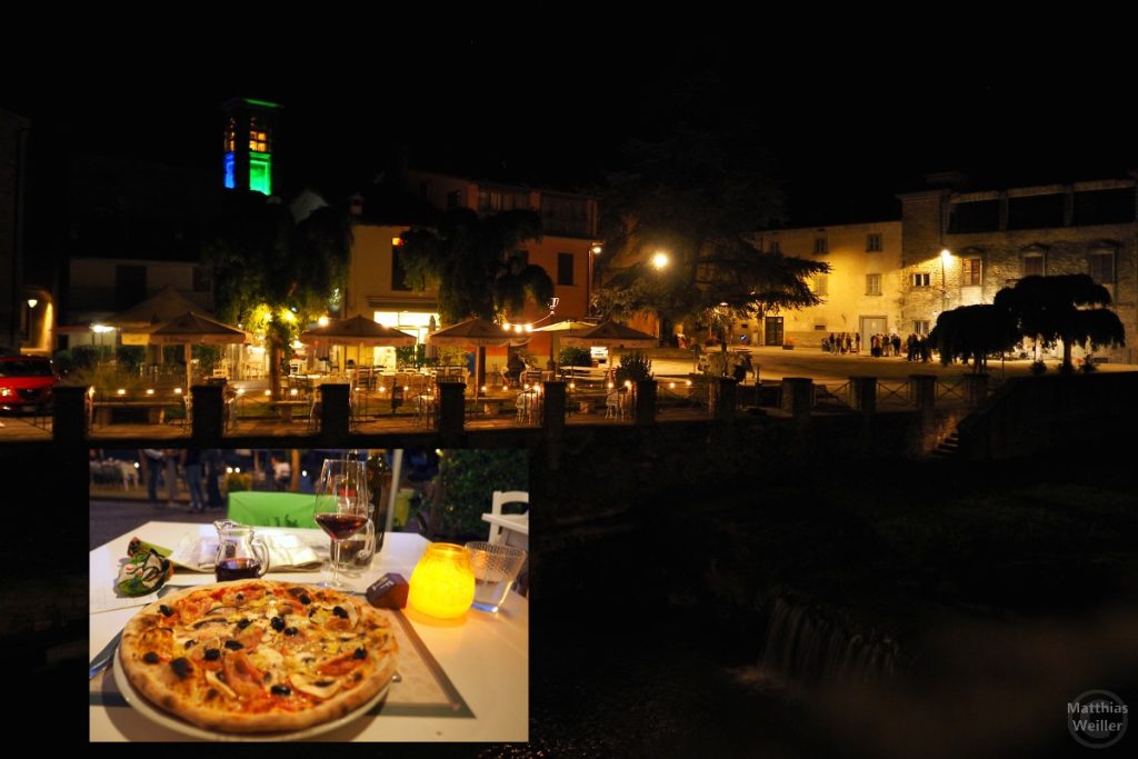 Tredozio in Nachtbeleuchtung mit farbigem Kirchturm/Gastgarten-Restaurant, Bild im Bild Pizza mit Rotwein